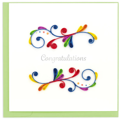 A photo of an intricately quilled greeting card made in Vietnam. This card features colorful swirls and 'Congratulations' written across the center.