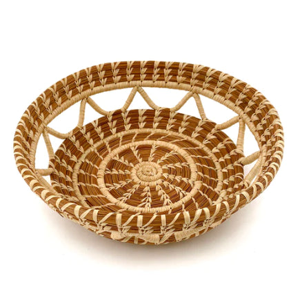 A photo of the Elena basket, which is a handwoven basket made in Guatemala out of Pine Needles and this one features a zig zag design with open see-through sections.