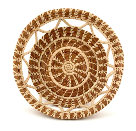 A photo of the top view of the Elena basket, which is a handwoven basket made in Guatemala out of Pine Needles and this one features a zig zag design with open see-through sections. 