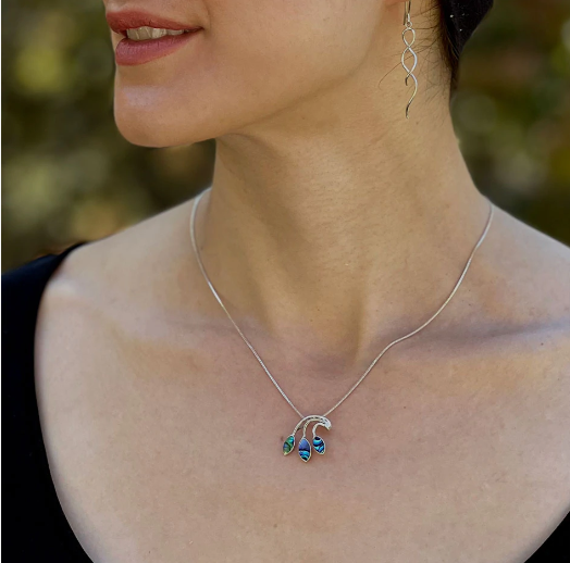 A photo of a model wearing the abalone leaf sterling silver necklace. 