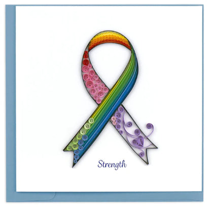 A photo of an intricately quilled art greeting card made from swirling paper in Vietnam. This card features the colors of the rainbow in a cancer ribbon with the word 'Strength' below it. 