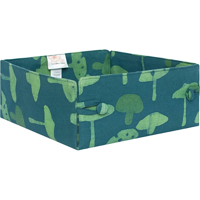 A photo of a textile material basket that is secured with buttons made fair trade in Ghana. This basket features green mushrooms on a blue background. 