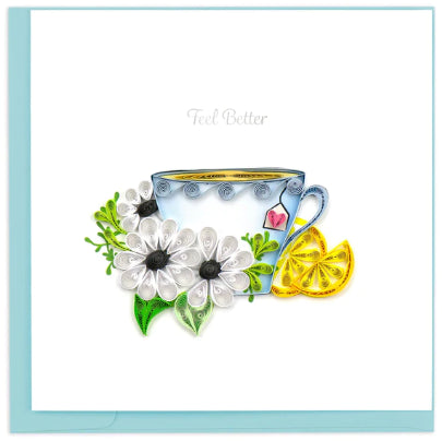 A photo of an intricately quilled greeting card made in Vietnam.  This one featured a cup of tea with a heart tag and flowers in front with lemon slices and 'Feel Better' is written below. 