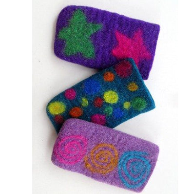 A photo of felt eyeglass holders that have colorful fun designs on them that vary, like swirls, dots, and stars. 