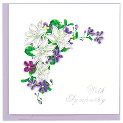 A photo of an intricately quilled art greeting card made from swirling paper in Vietnam. This card featured a purple and white floral display with 'With Sympathy' written.