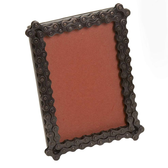 A photo of a picture frame, but the border is made of recycled bicycle chain. 