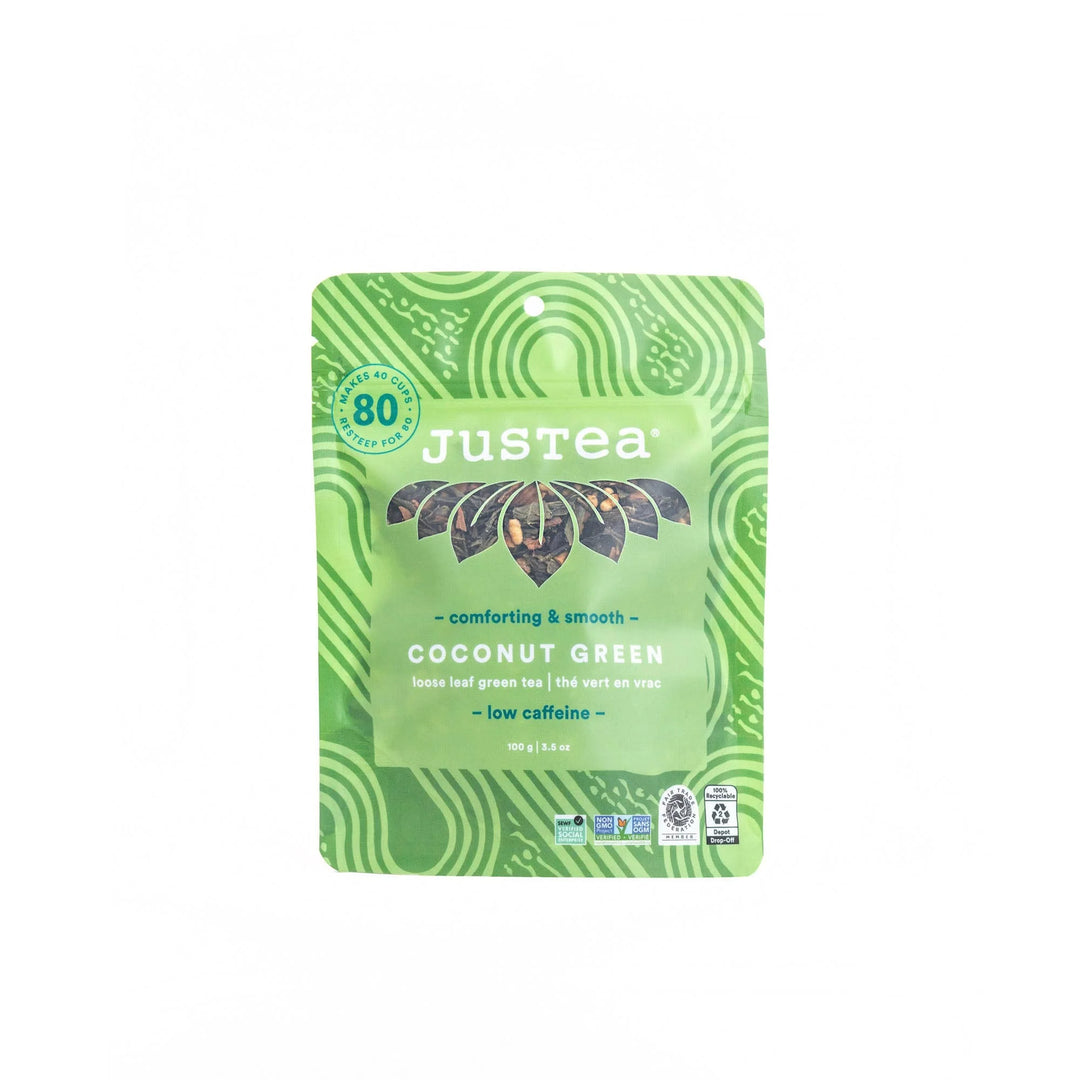 A photo of a stand-up pouch with loose leaf tea from Justea. This is the Coconut Green tea, described as 'comforting & smooth'.