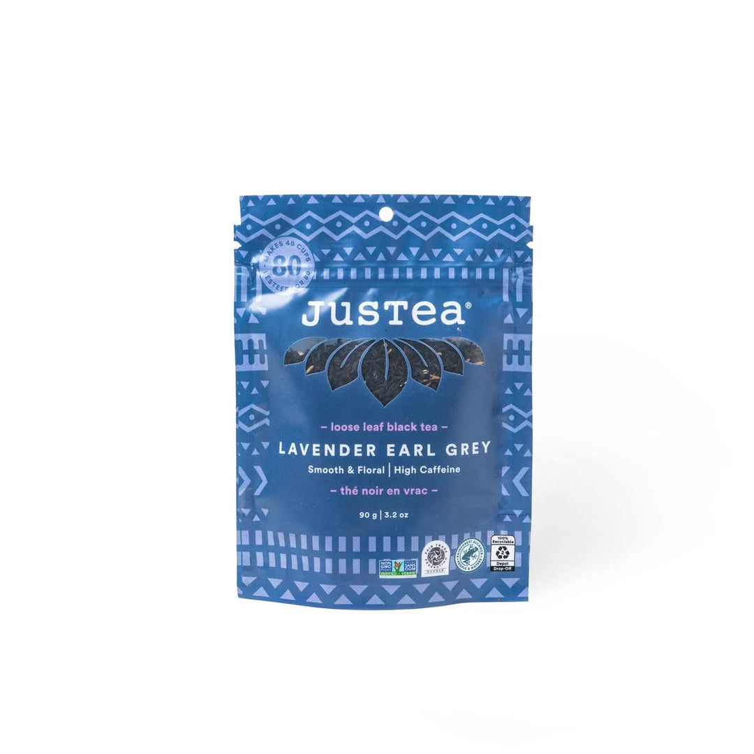 A photo of a stand-up pouch with loose leaf tea from Justea. This is the Lavender Earl Grey Black tea, described as 'Smooth & Floral' with High Caffeine. 