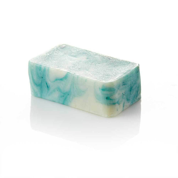 A photo of a Lime Coconut soap bar that is marbled blue and white. 