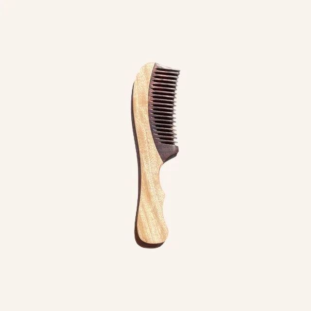 A photo of a neem and rosewood comb made in India to stimulate hair growth. 