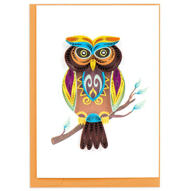 A photo of a small gift enclosure quilling card with a colorful and intricate design of an owl on the front. It is colored with bright yellow, purples, and blues to highlight the brown owl's features. 
