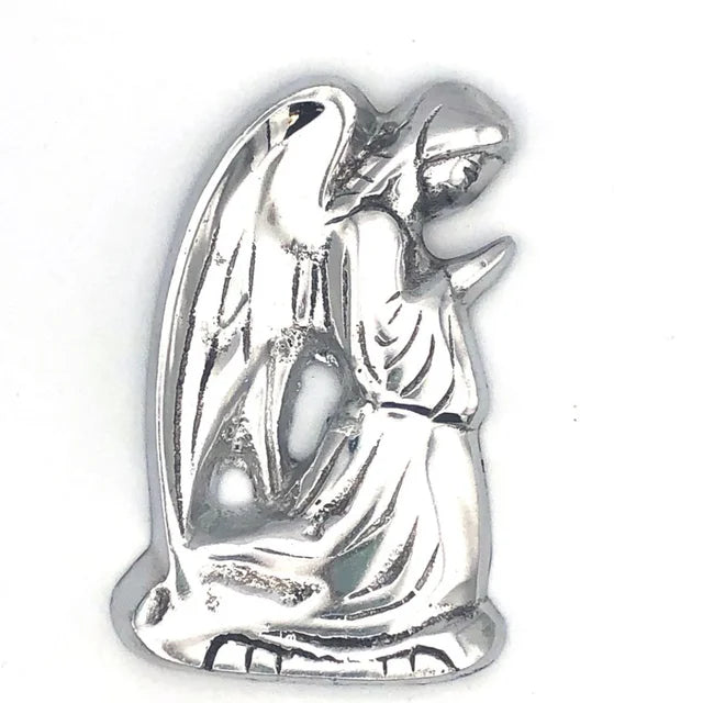 A photo of a praying angel decor item that is made of recycled metal from melting down car parts in Nicaragua. 
