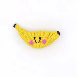 A photo of a hand crocheted rattle made in Bangladesh. This one is a yellow banana. 