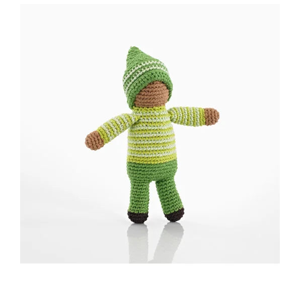 A photo of a hand crocheted rattle made in Bangladesh. This one is a pixie doll wearing a green outfit. 
