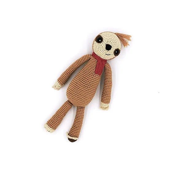 A photo of a hand crocheted rattle made in Bangladesh. This one is a sloth wearing a red scarf. 