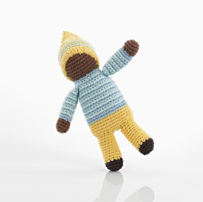 A photo of a hand crocheted rattle made in Bangladesh. This one is a pixie doll wearing a yellow outfit. 