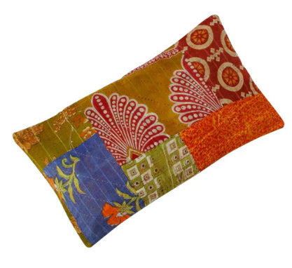 A photo of a motif pillow made of patchwork from sari material. 
