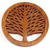 A photo of a wood trivet made of shesham wood and in the shape of the tree of life. 