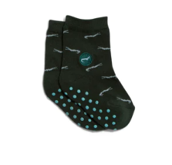 A photo of a pair of green kids socks with rubber pads on the bottom adorned with crocodiles that help save crocodiles through non-profit donations with each purchase of these fair trade socks made in India.