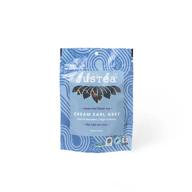 A photo of a stand-up pouch with loose leaf tea from Justea. This is the Cream Early Grey Black Tea. 
