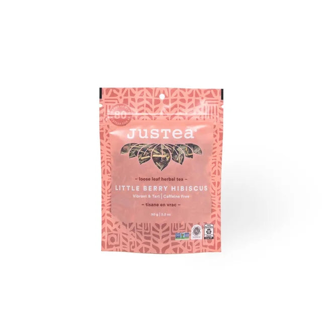 A photo of a stand-up pouch with loose leaf tea from Justea. This is the Little Berry Hibiscus Herbal Tea. 