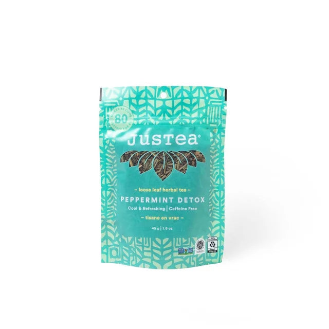 A photo of a stand-up pouch with loose leaf tea from Justea. This is the Peppermint Detox Herbal Tea. 