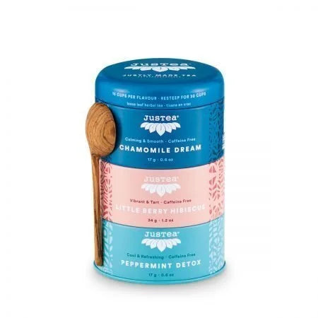 A photo of a tea trio from Justea. The tea comes in a 3 pack canister with a wooden spoon. This is the herbal trio with Chamomile Dream, Little Berry Hibiscus, and Peppermint Detox.