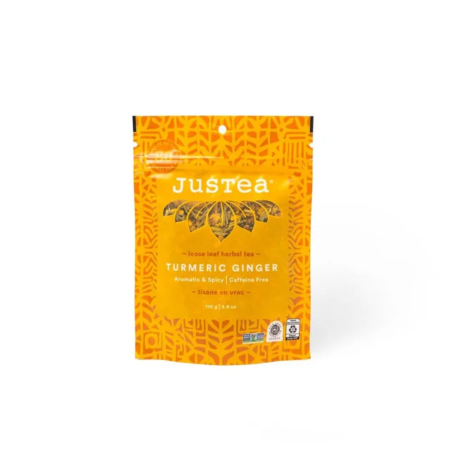 A photo of a stand-up pouch with loose leaf tea from Justea. This is the Turmeric Ginger Herbal Tea. 