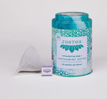 A photo of a container with tea bags from Justea. This is the Peppermint Detox Herbal Tea. 