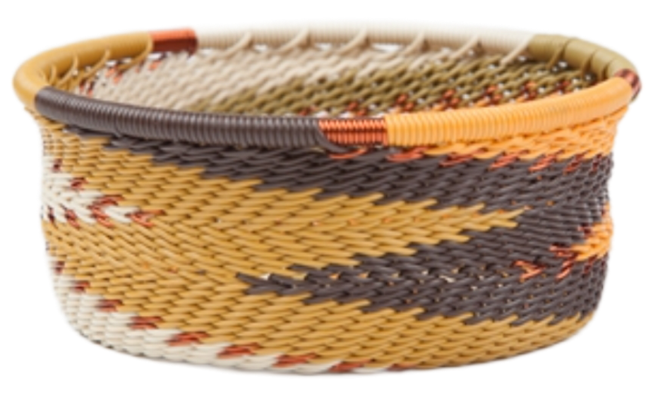 A photo of a small dish that is weaved like a basket made out of telephone wire with colors representing the african earth, with natural tones of greens, creams, browns, and oranges. 