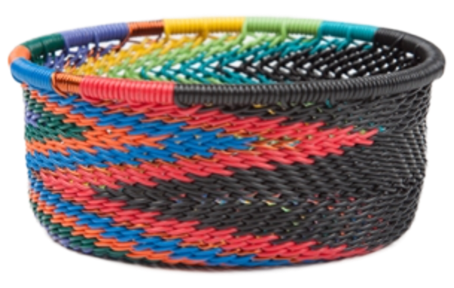 A photo of a small dish that is weaved like a basket made out of telephone wire with colors of the rainbow with bold black. 