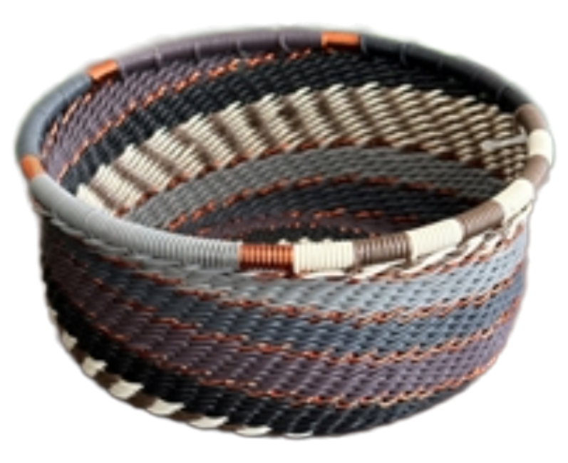 A photo of a small dish that is weaved like a basket made out of telephone wire with colors representing grey mist, with deep variations of grey with gold accents. 