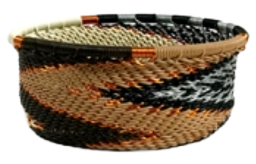A photo of a small dish that is weaved like a basket made out of telephone wire with colors representing mocha colors; browns, blacks, reams and white with gold accents. 