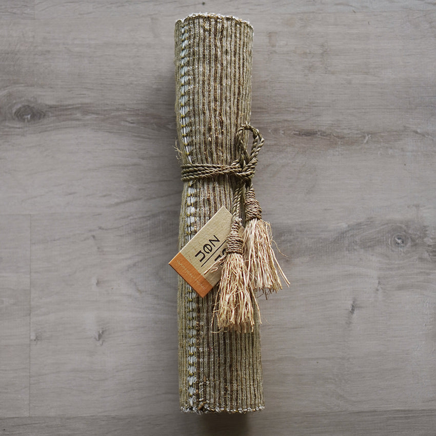 A photo of the Beige table runner wound up packaged for easy storage.