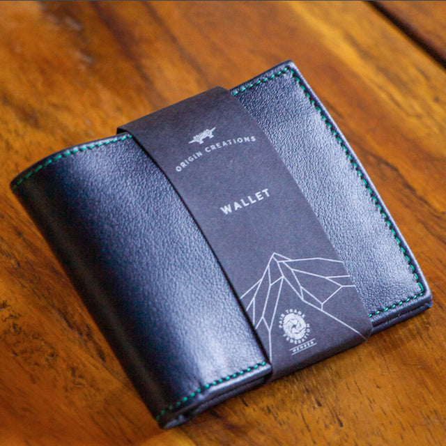 A photo of a dark blue wallet made of ethical leather in Nicaragua. 