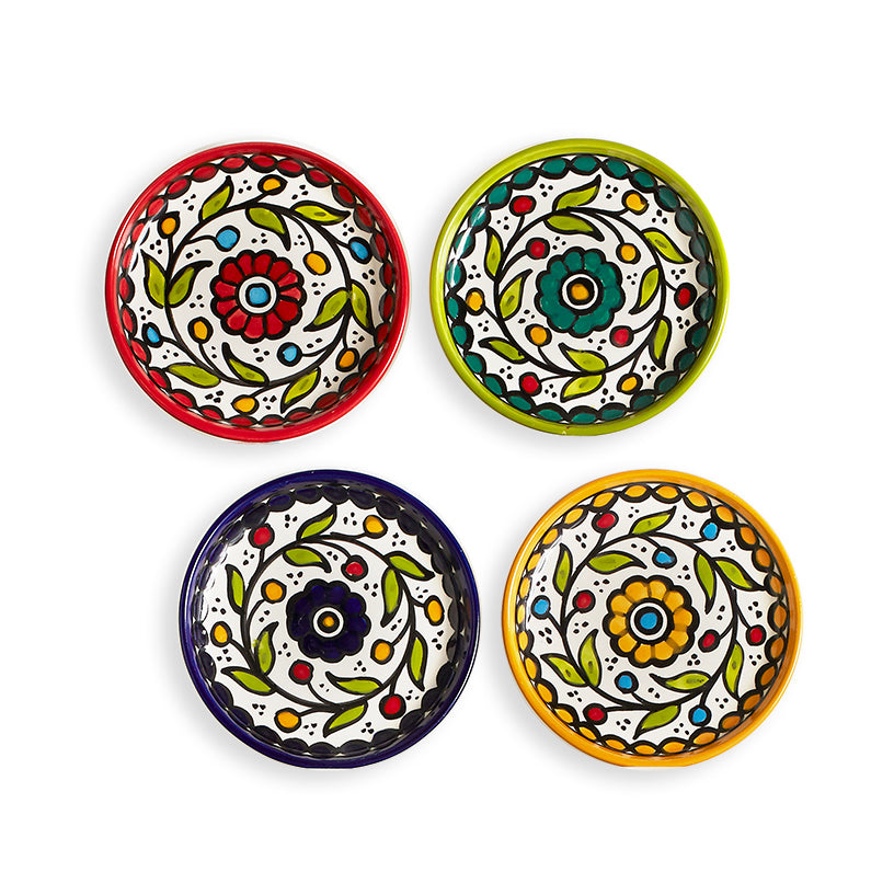 A image of 4 appetizer plates hand painted in various colors by fair trade artisans in West Bank 