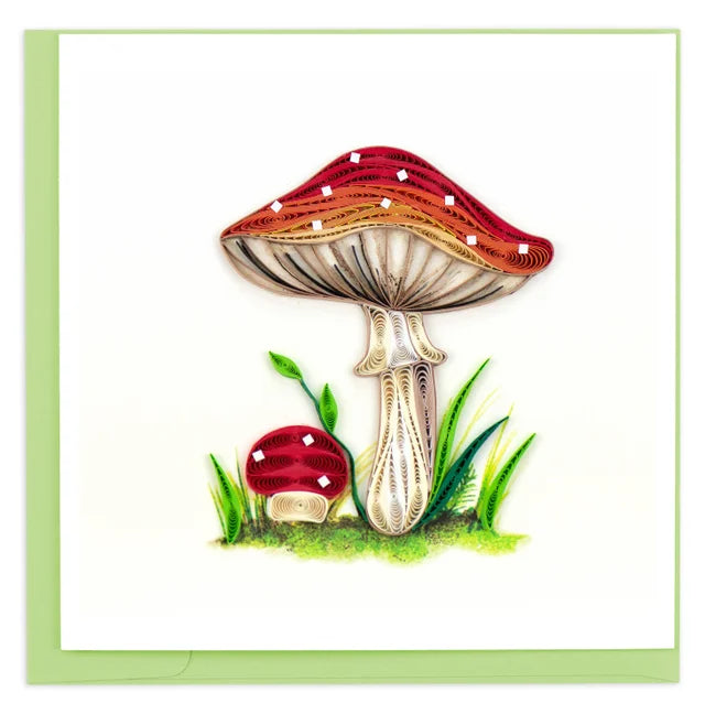 A photo of an intricately quilled greeting card made in Vietnam. This card features a wild mushroom and a baby mushroom. 